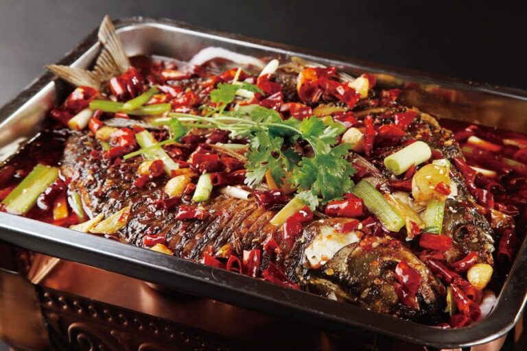 Spicy grilled whole fish in a sizzling tray